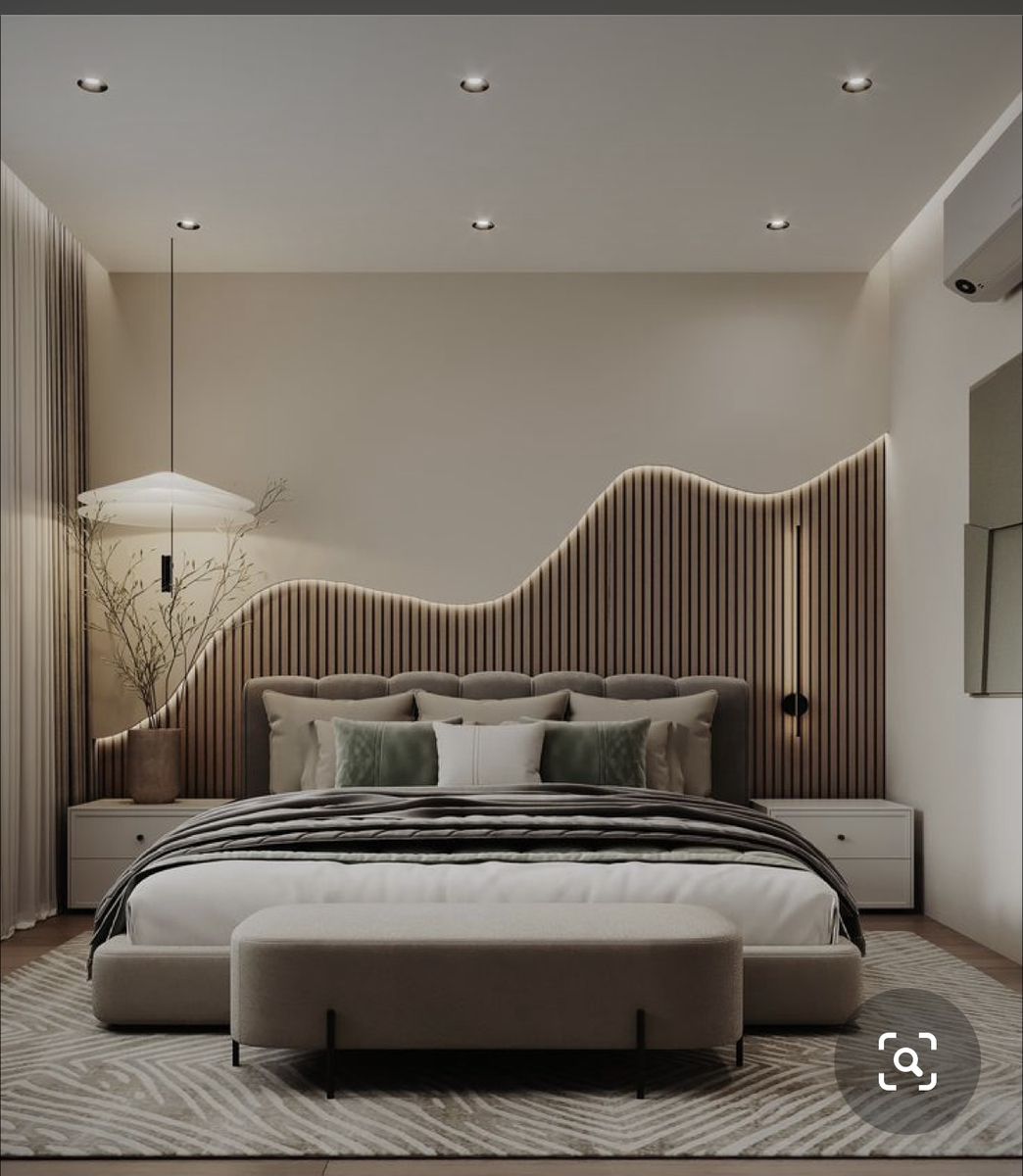 Modern bedroom renovation in Dubai with upholstered bed, custom wooden paneling, LED lighting, and stylish interiors by Interiors Fit Out – trusted apartment renovation company in Dubai